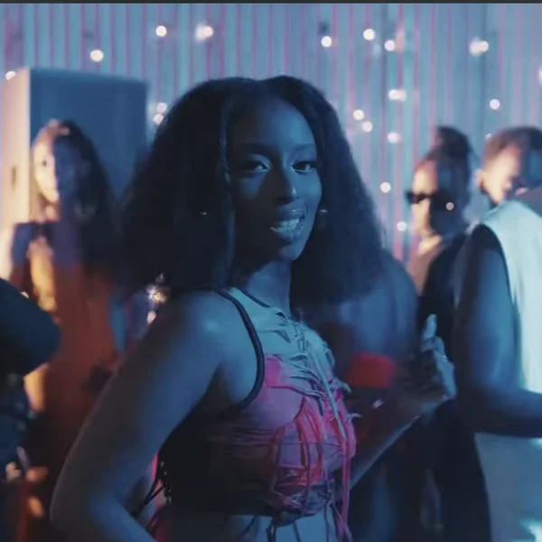 A still from the video for “Bounce” showing Angell Mutoni and Kivumbi King standing behind her. 