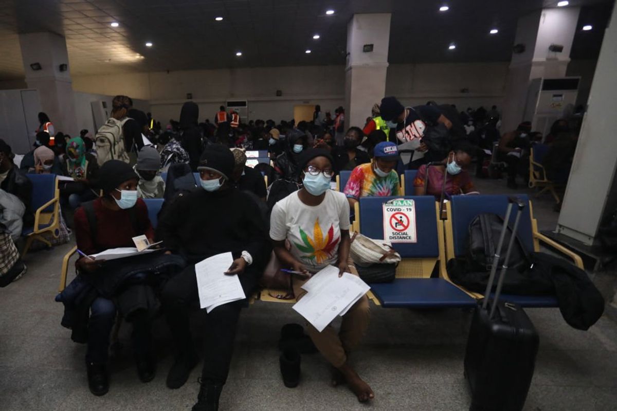 A group of Nigerian students fill out their data at Nnamdi Azikiwe airport.