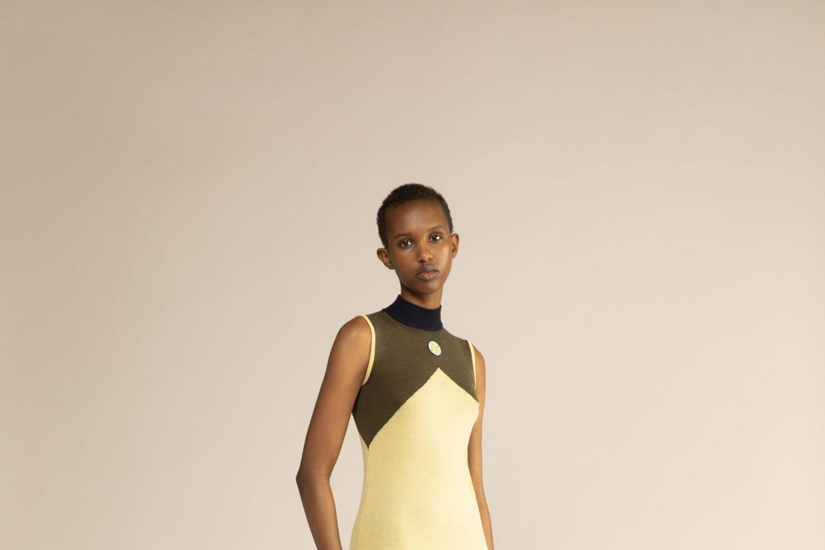 A model wears a Luhkanyo Mdingi olive-green and yellow dress