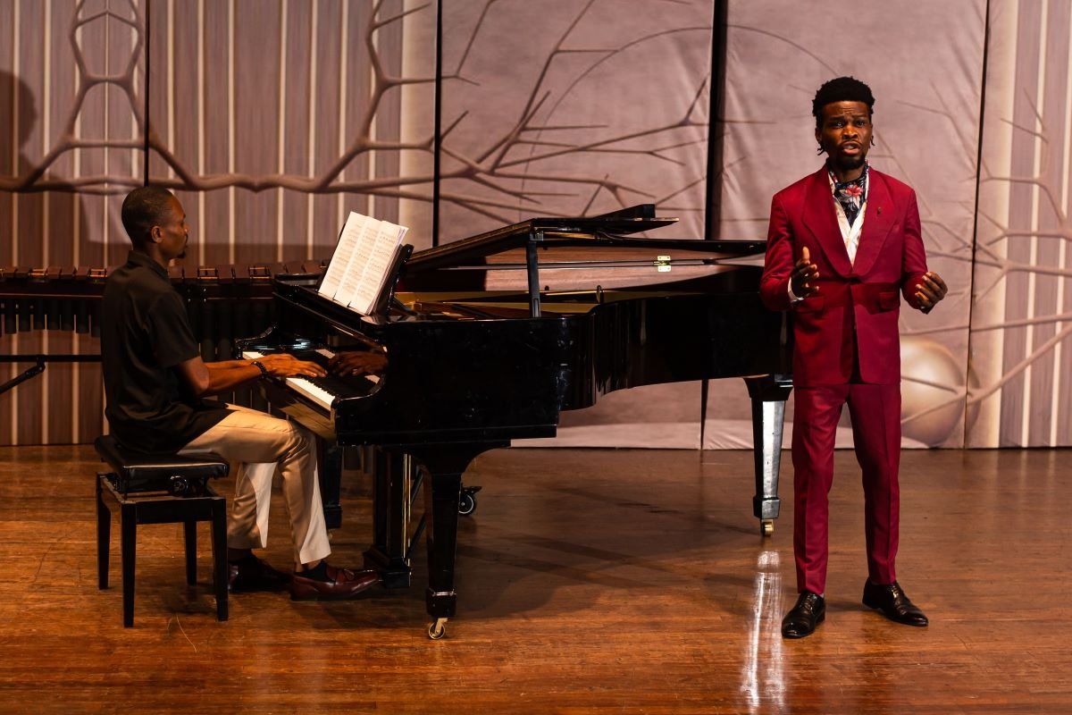 A photo of classical musician Victor Ige performing with a pianist.