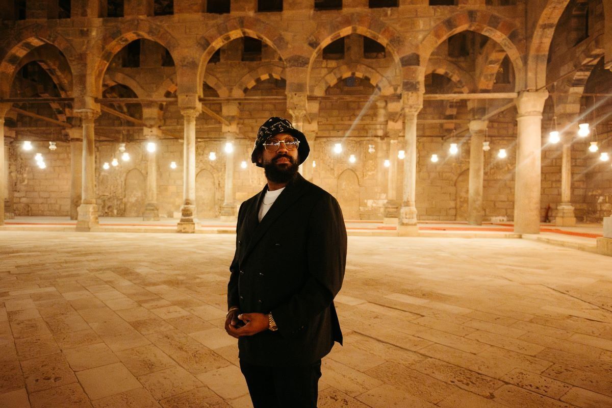 A photo of PJ Morton in an old Egyptian building.