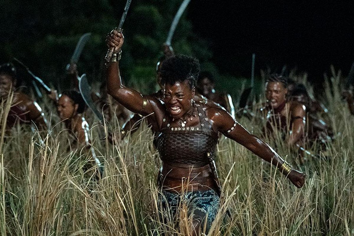 A still from the film The Woman King of actress Viola Davis wielding a machete