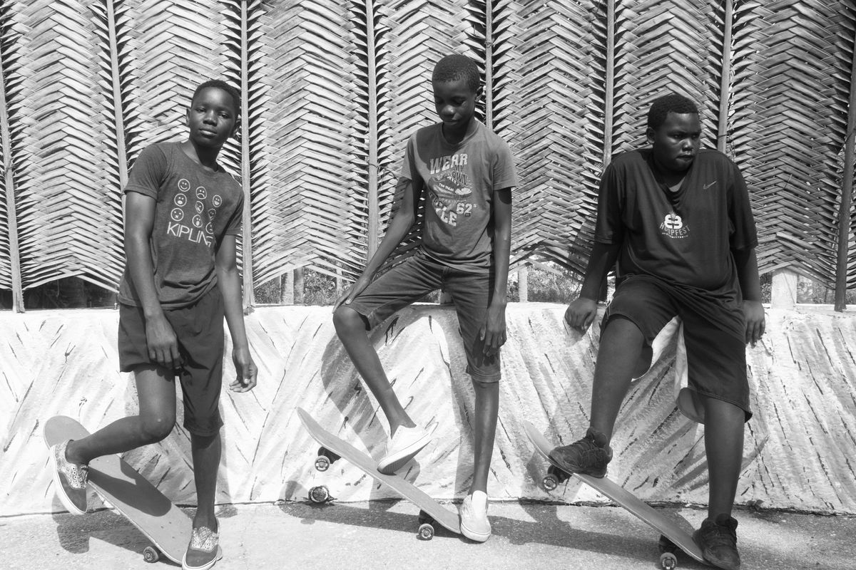 An image of three young skate-boarders