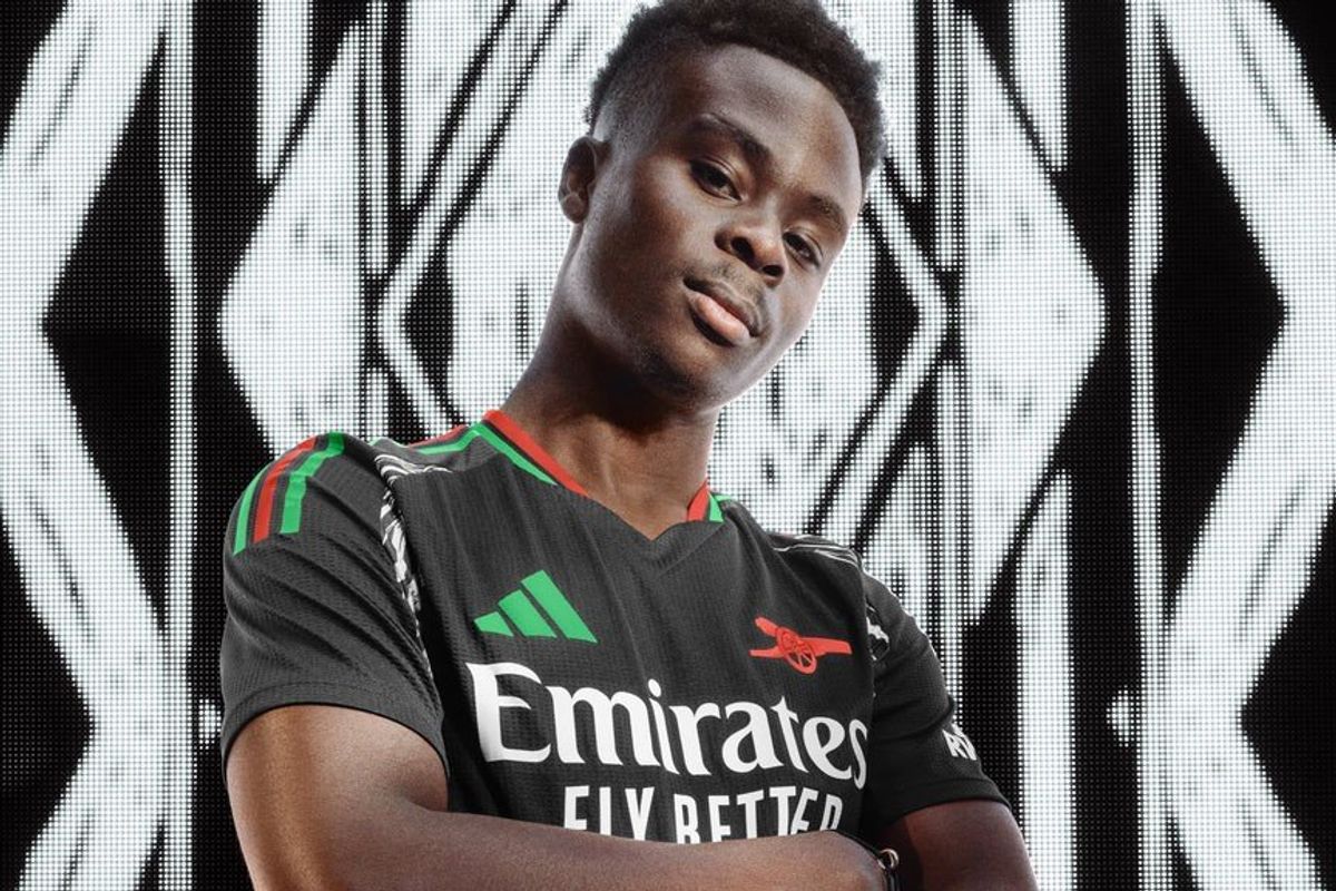 Bukayo Saka poses for a photo with the new Arsenal away kit for the 2024/25 season.