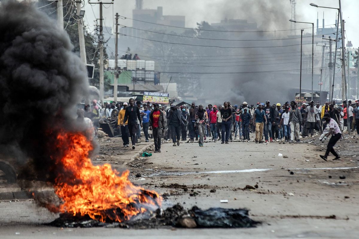 Kenyan opposition supporters react and throw stones towards Kenya Police officers during demonstrations in Nairobi, Kenya on July 12, 2023. Kenyan opposition leader Raila Odinga has called once again for countrywide demonstrations on Wednesday as he puts pressure on President William Ruto's administration. Opposition leaders accuse the government of being illegitimate while failing to tackle the high cost of living as they have launched a national campaign to raise signatures from Kenyans in their push to remove President William Ruto from office.