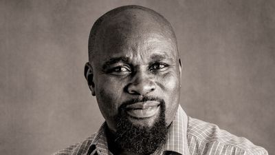 Uchenna Awoke stares forward at a camera with a slight smile.