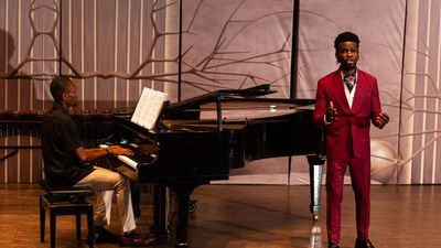 A photo of classical musician Victor Ige performing with a pianist.