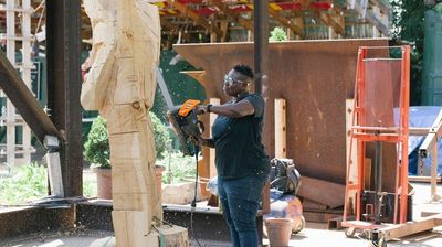 A Photo of Leilah Babirye working on a sculpture project.