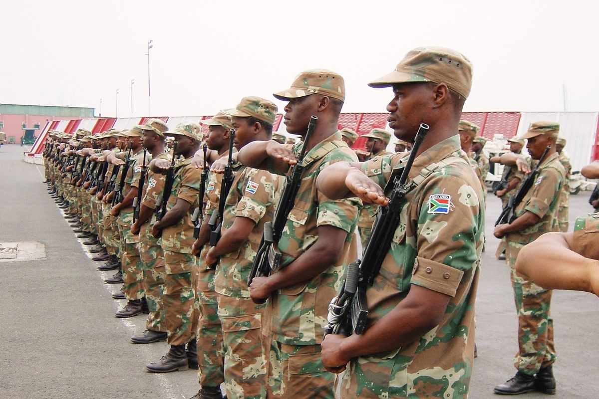 South African troops, serving as peacekeepers with the African Union Mission in Burundi salute the arrival of Major General Siphiwe Nyanda, chief of the South African National Defence Force, Bujumbura, Burundi, 27th August 2003