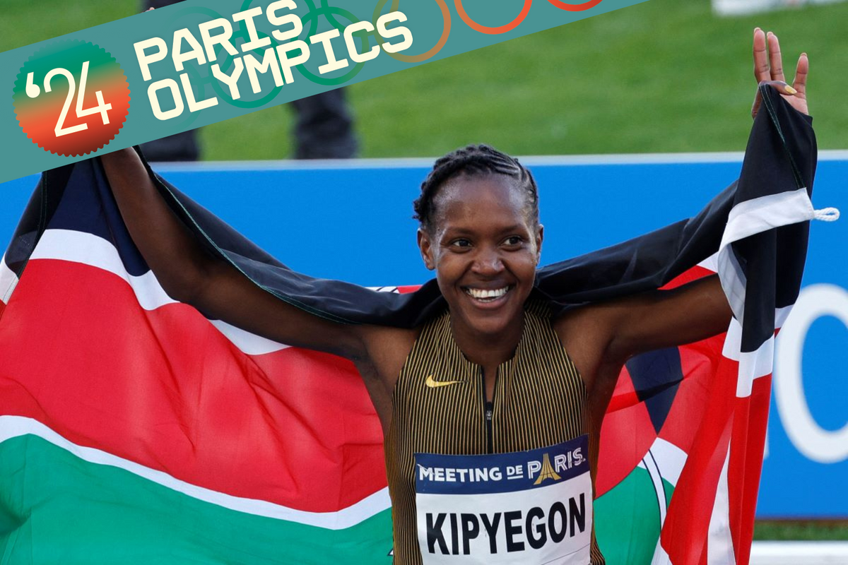 A photo of Faith Kipyegon holding the Kenyan national flag and smiling.