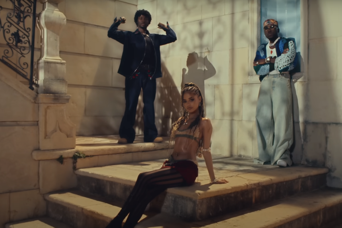 A still from the music video for ‘One Call’ showing Tyla, Omah Lay, and SPINALL.