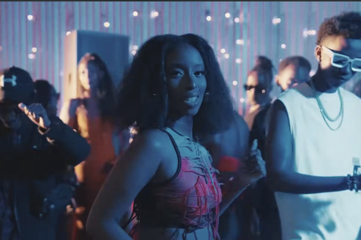 A still from the video for “Bounce” showing Angell Mutoni and Kivumbi King standing behind her.