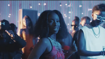 A still from the video for “Bounce” showing Angell Mutoni and Kivumbi King standing behind her. 