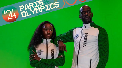 A photo of two models wearing the Nigerian 2024 Olympics white tracksuit with green sleeves, designed by Actively Black.